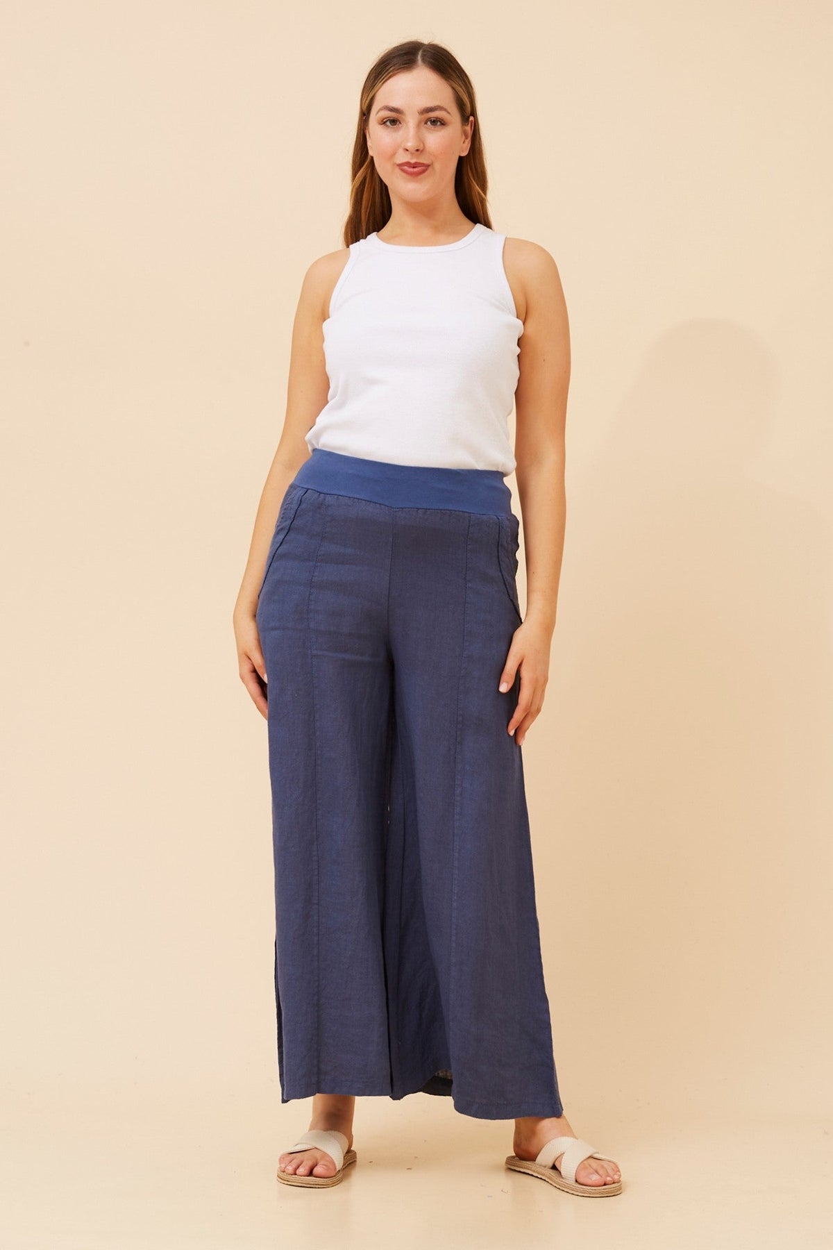 Image of a model wearing Pants. Product name - AMILITA WIDE LEG LINEN PANTS in Navy colour by brand - BOTTEGA MODA