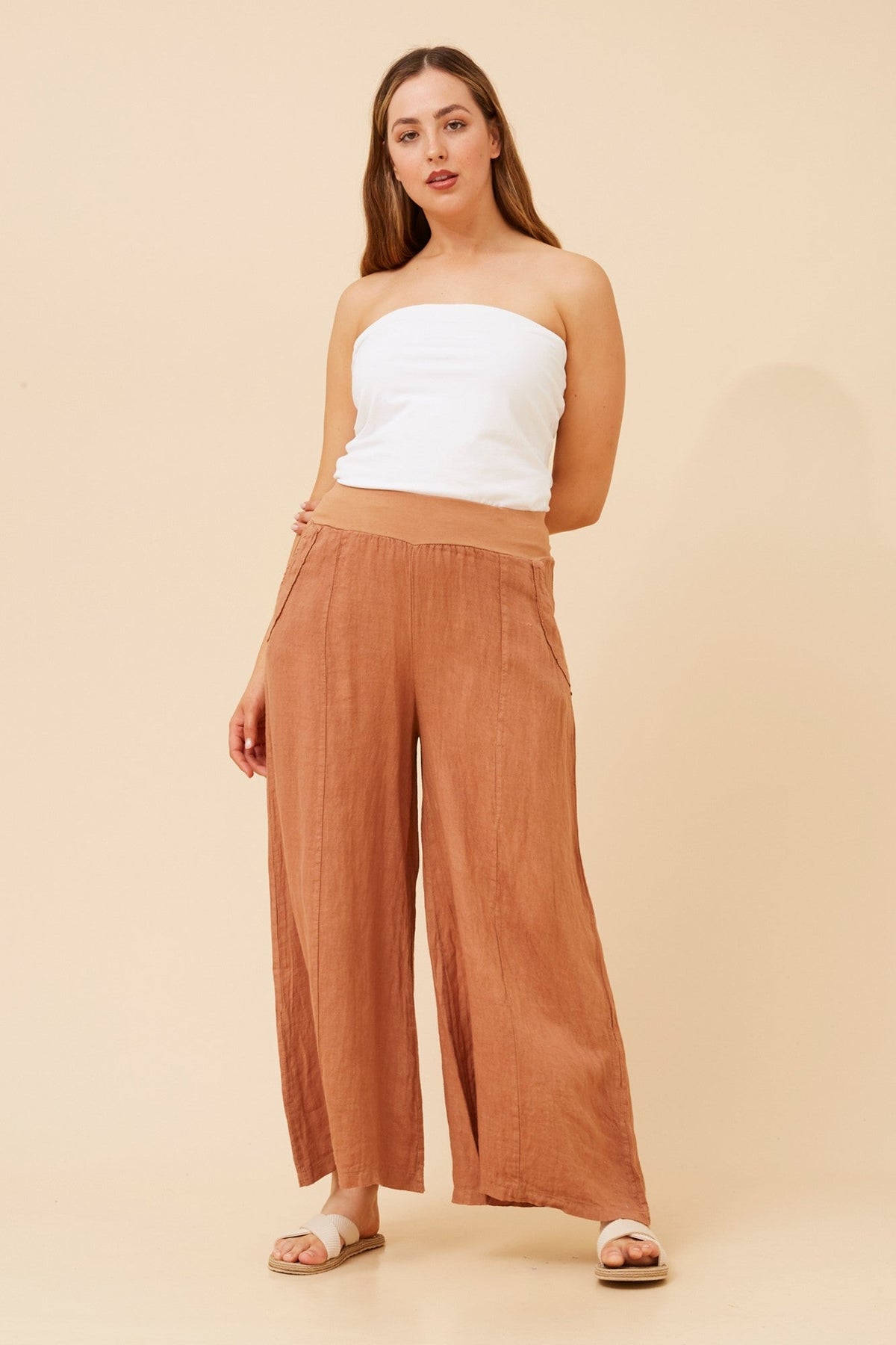 Image of a model wearing Pants. Product name - AMILITA WIDE LEG LINEN PANTS in Tobacco colour by brand - BOTTEGA MODA