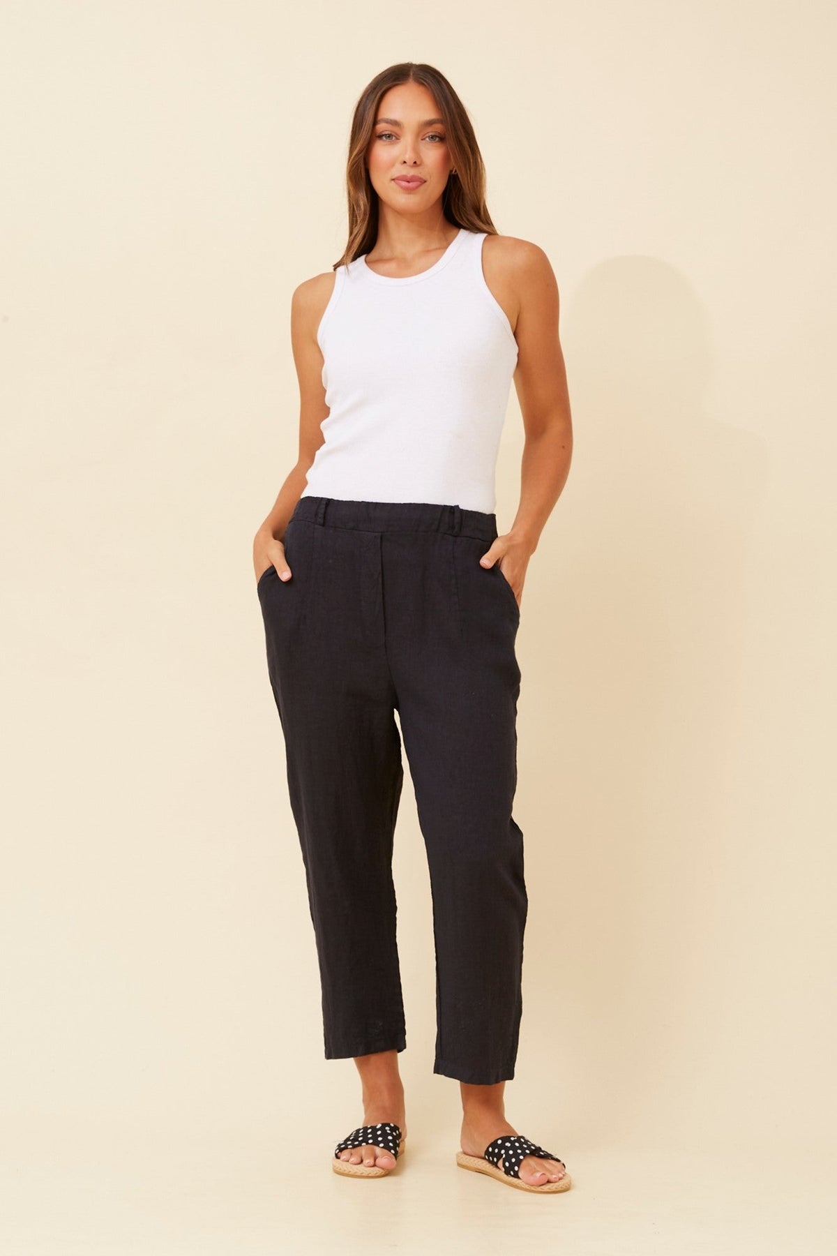 Image of a model wearing Pants. Product name - GENETTA SOLID LINEN PANTS in Linen colour by brand - BOTTEGA MODA