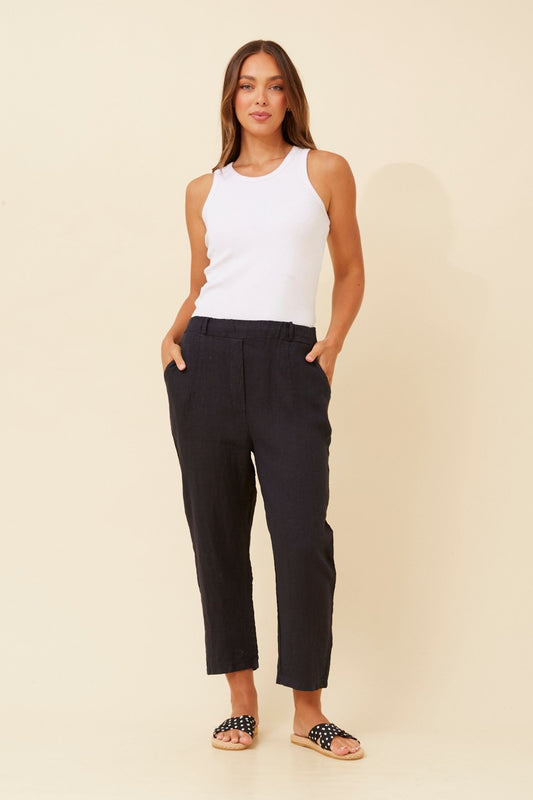Image of a model wearing Pants. Product name - GENETTA SOLID LINEN PANTS in Linen colour by brand - BOTTEGA MODA