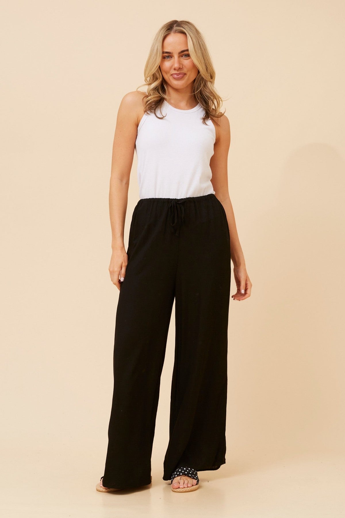 Image of a model wearing Pants. Product name - DONNY LINEN BLEND PANTS in Black colour by brand - Caroline Morgan Australia