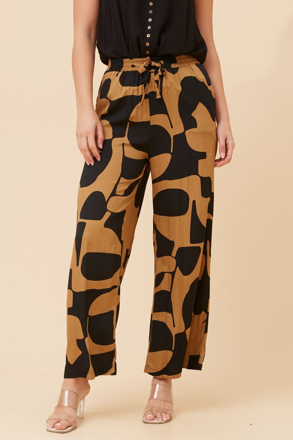 Image of a model wearing Pants. Product name - SUZZEL ABSTRACT PRINT PANTS in Toffee colour by brand - Caroline Morgan Australia