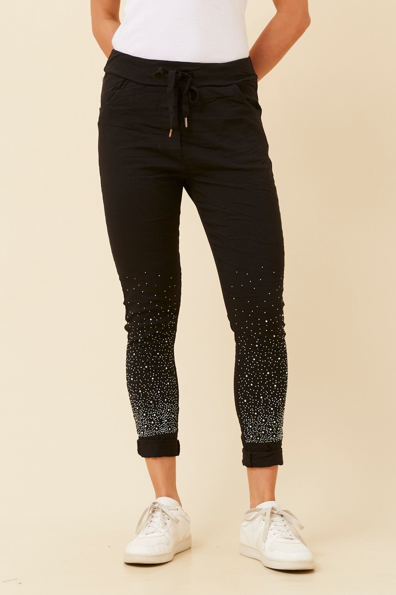Image of a model wearing Pants. Product name - JANJA DIAMANTE JOGGER PANTS in Black colour by brand - BOTTEGA MODA