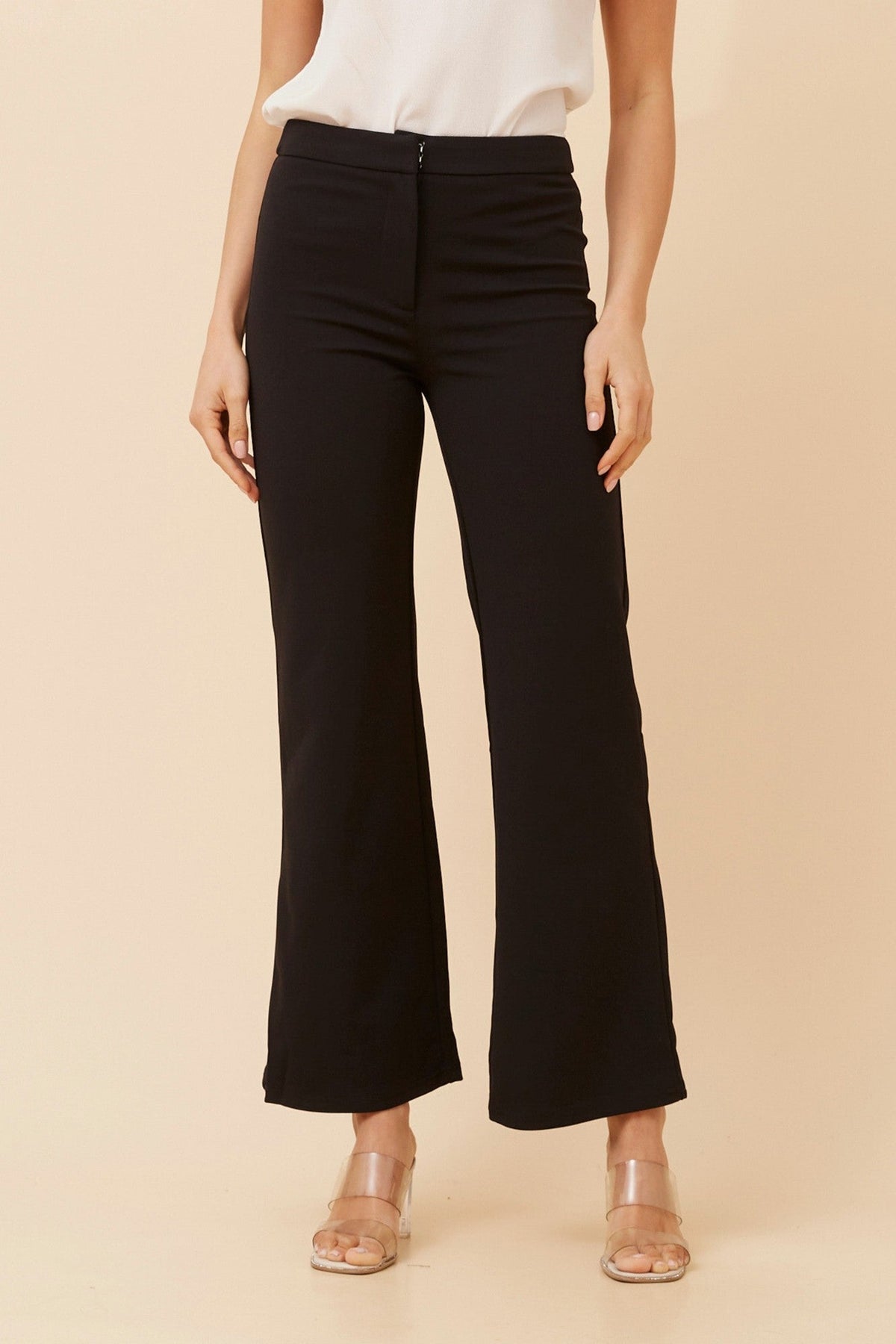 Image of a model wearing Pants. Product name - LILIA WIDE LEG PANTS in Black colour by brand - Caroline Morgan Australia