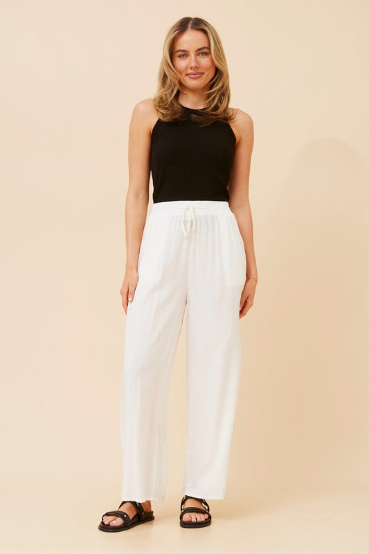 Image of a model wearing Pants. Product name - SUZZEL SOLID WIDE LEG PANTS in White colour by brand - Caroline Morgan Australia