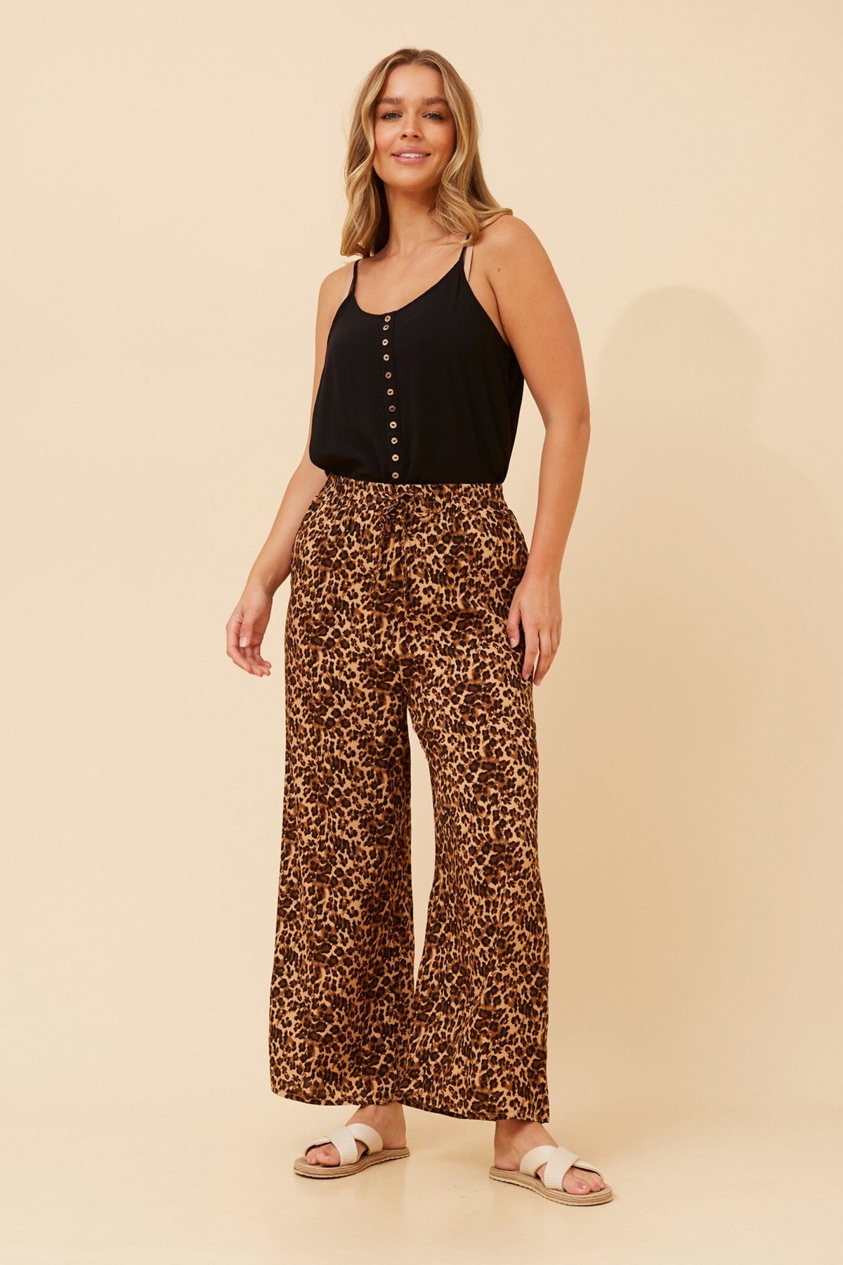 Image of a model wearing Pants. Product name - SUZZEL ANIMAL PRINT PANTS in Multi Beige colour by brand - Caroline Morgan Australia