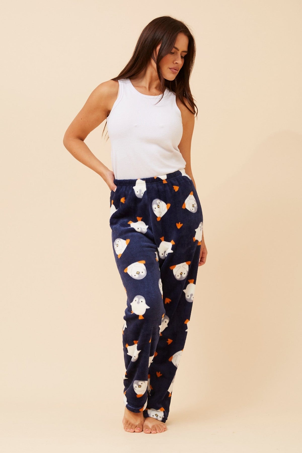 Image of a model wearing Pants. Product name - LEE PENGUIN PRINT PYJAMA PANTS in Multi Navy colour by brand - Caroline Morgan Australia
