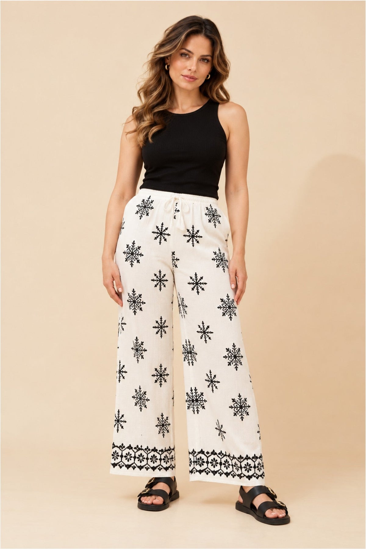 Image of a model wearing Pants. Product name - KARSYN EMBROIDERY PRINT PANTS in White colour by brand - Caroline Morgan Australia