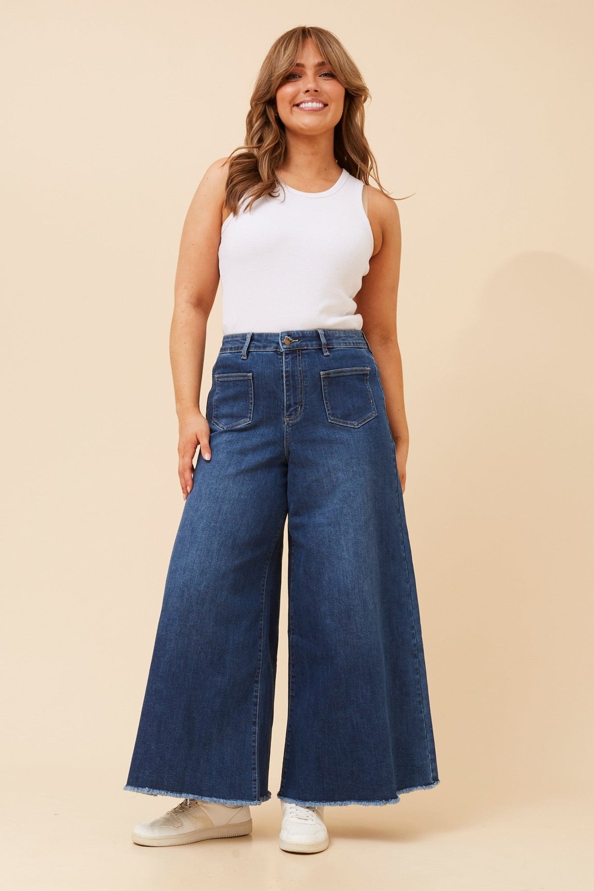 Image of a model wearing Pants. Product name - YOSEF DENIM WIDE LEG PANTS in Mid Denim colour by brand - INFINITY DENIM