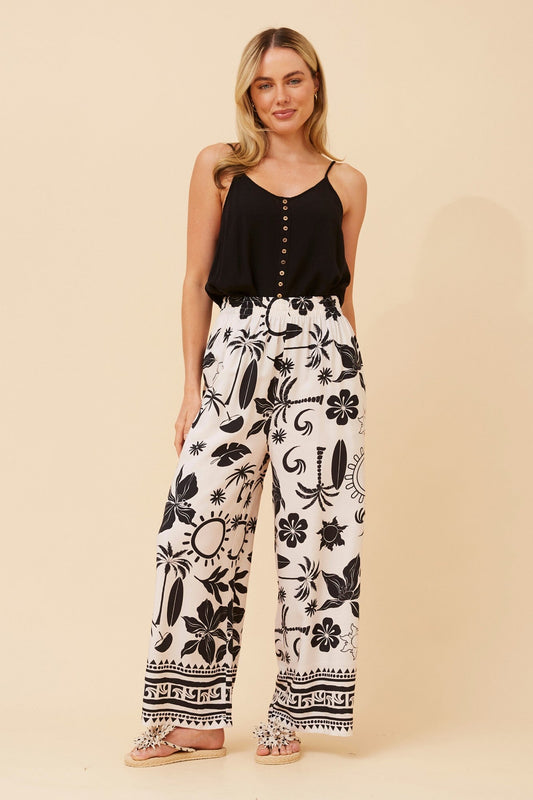 Image of a model wearing Pants. Product name - ANCA BORDER PRINT PANTS in Multi Black colour by brand - Caroline Morgan Australia