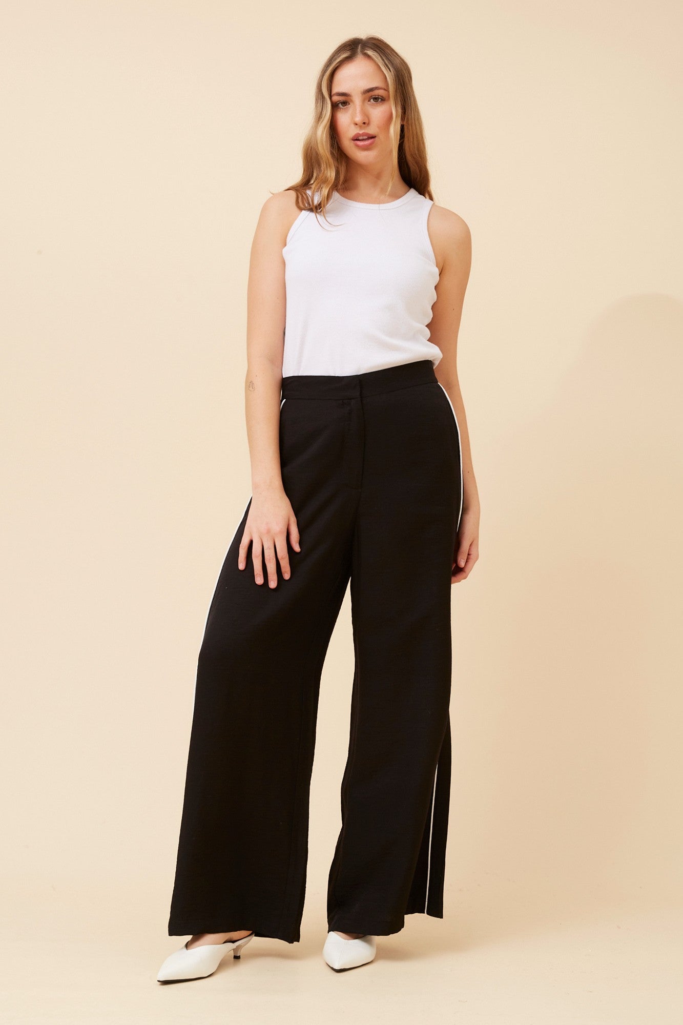Image of a model wearing Pants. Product name - MIRIELLE SOLID WIDE LEG PANTS in Black colour by brand - Caroline Morgan Australia