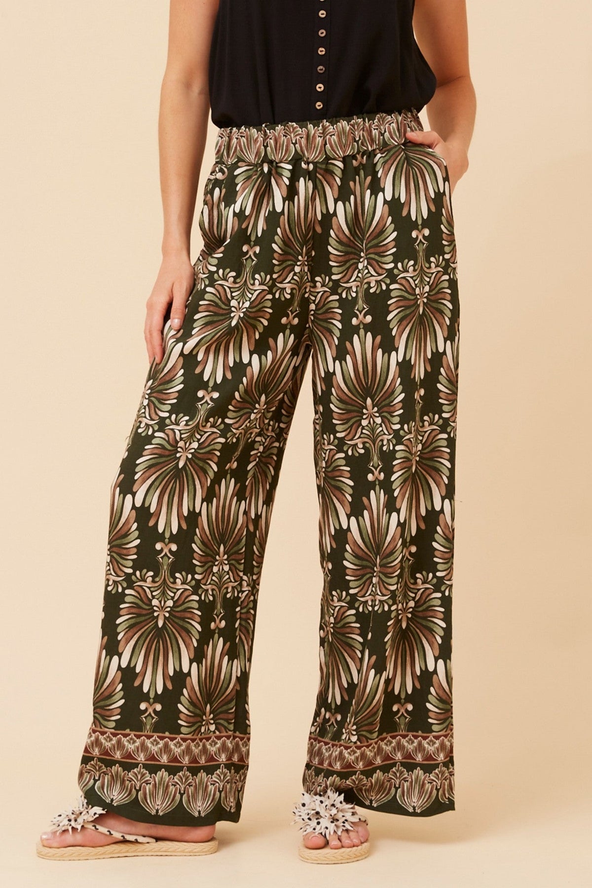 Image of a model wearing Pants. Product name - LAVERNE ABSTRACT PRINT WIDE LEG PANTS in Khaki colour by brand - Caroline Morgan Australia