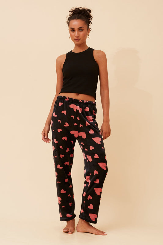 Image of a model wearing Pants. Product name - LEE HEART PRINT PYJAMA PANTS in Black colour by brand - Caroline Morgan Australia