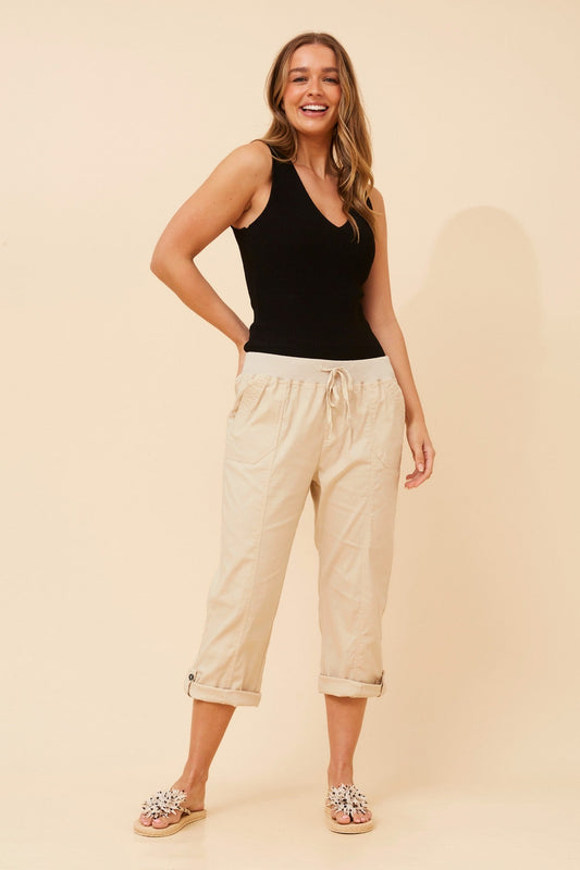 Image of a model wearing Pants. Product name - YOLLIE SOLID CROP PANTS in Walnut colour by brand - Caroline Morgan Australia