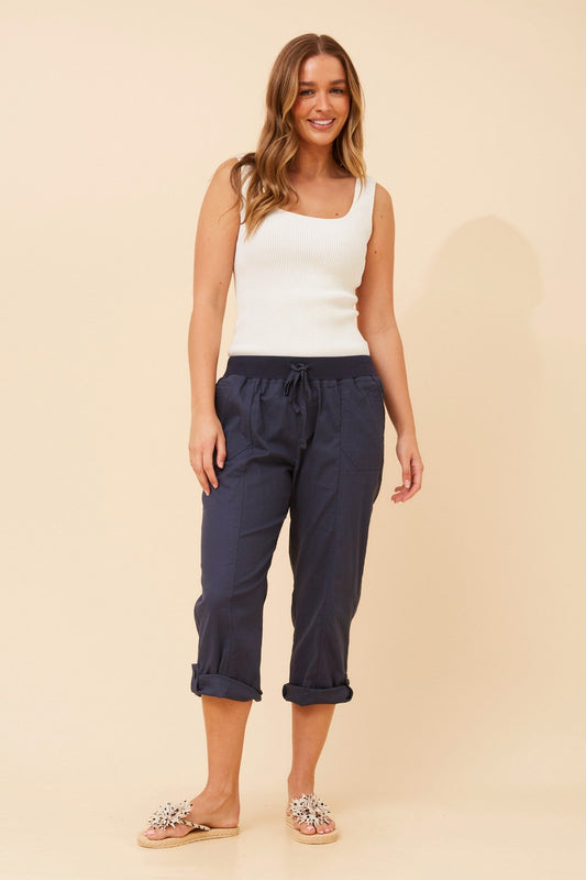 Image of a model wearing Pants. Product name - YOLLIE SOLID CROP PANTS in Navy colour by brand - Caroline Morgan Australia