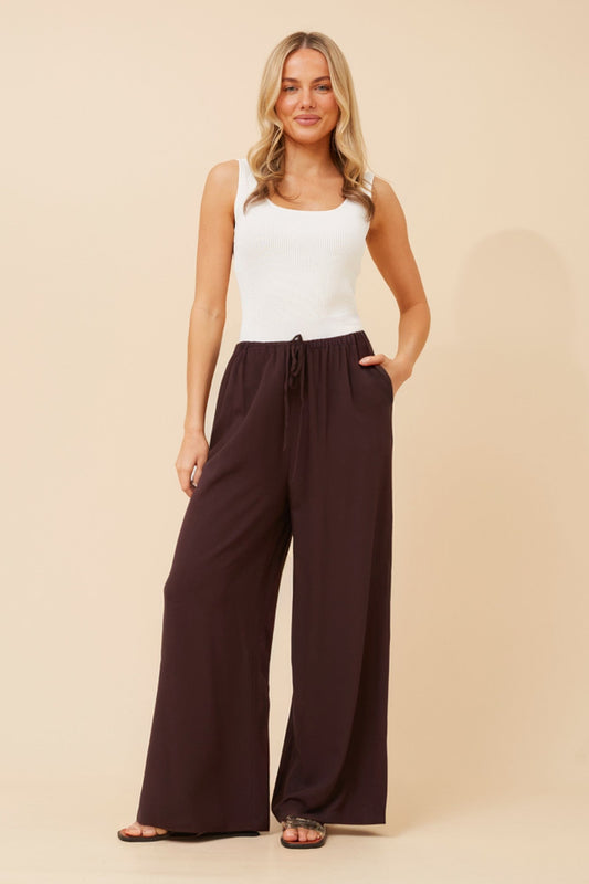 Image of a model wearing Pants. Product name - DONNY SOLID WIDE LEG PANTS in Chocolate colour by brand - Caroline Morgan Australia