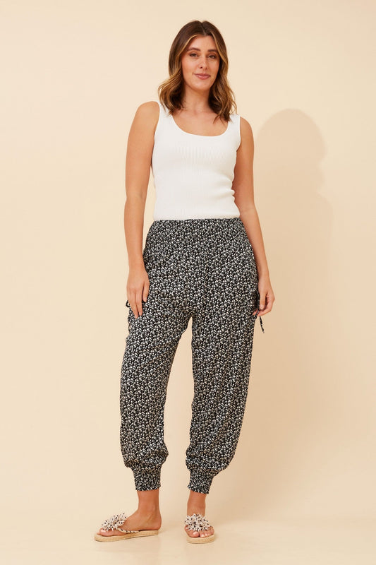 Image of a model wearing Pants. Product name - HAREM ABSTRACT PRINT PANTS in Black And White colour by brand - Caroline Morgan Australia