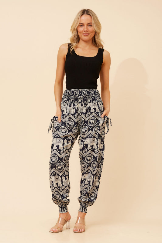 Image of a model wearing Pants. Product name - HAREM ELEPHANT PRINT PANTS in Navy colour by brand - Caroline Morgan Australia