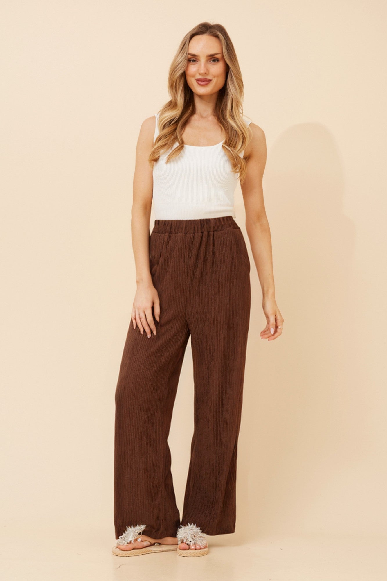 Image of a model wearing Pants. Product name - MERCER SOLID WIDE LEG PANTS in Chocolate colour by brand - Caroline Morgan Australia