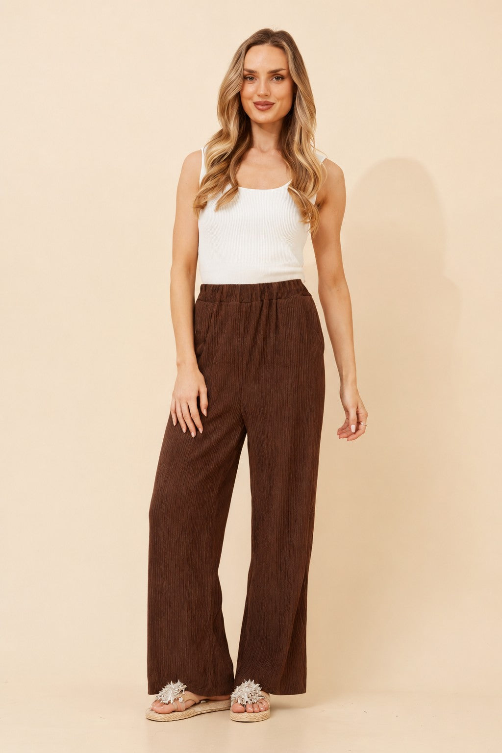 Image of a model wearing Pants. Product name - MERCER SOLID WIDE LEG PANTS in Chocolate colour by brand - Caroline Morgan Australia