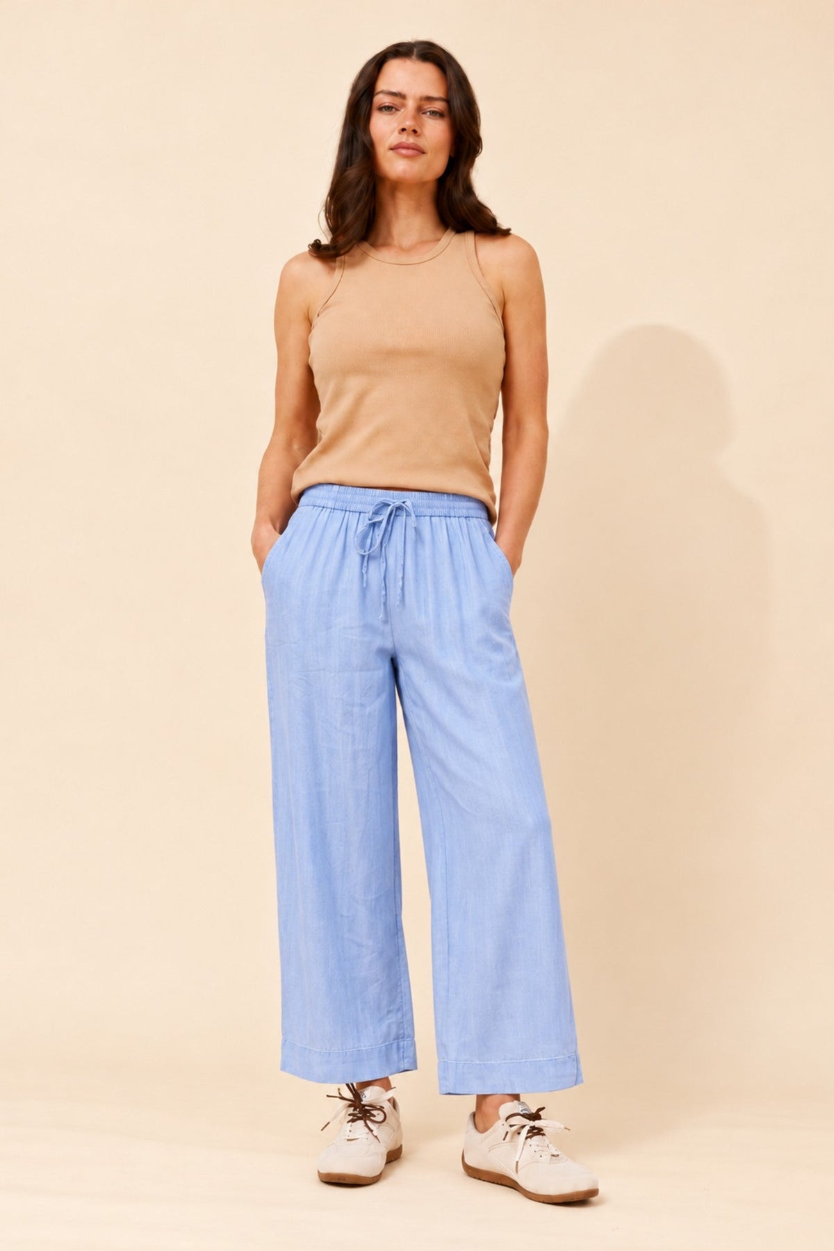 Image of a model wearing Pants. Product name - ALLORAH SOLID WIDE LEG PANTS in Light Denim colour by brand - MYSTIC MONSOON