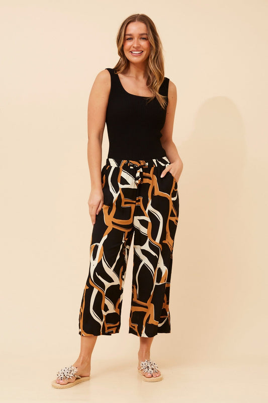 Image of a model wearing Pants. Product name - SUZE ABSTRACT PRINT CULOTTE PANTS in Toffee colour by brand - Caroline Morgan Australia
