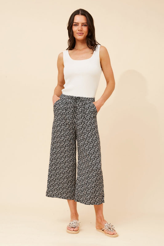 Image of a model wearing Pants. Product name - SUZE ABSTRACT PRINT CULOTTES in Black And White colour by brand - Caroline Morgan Australia