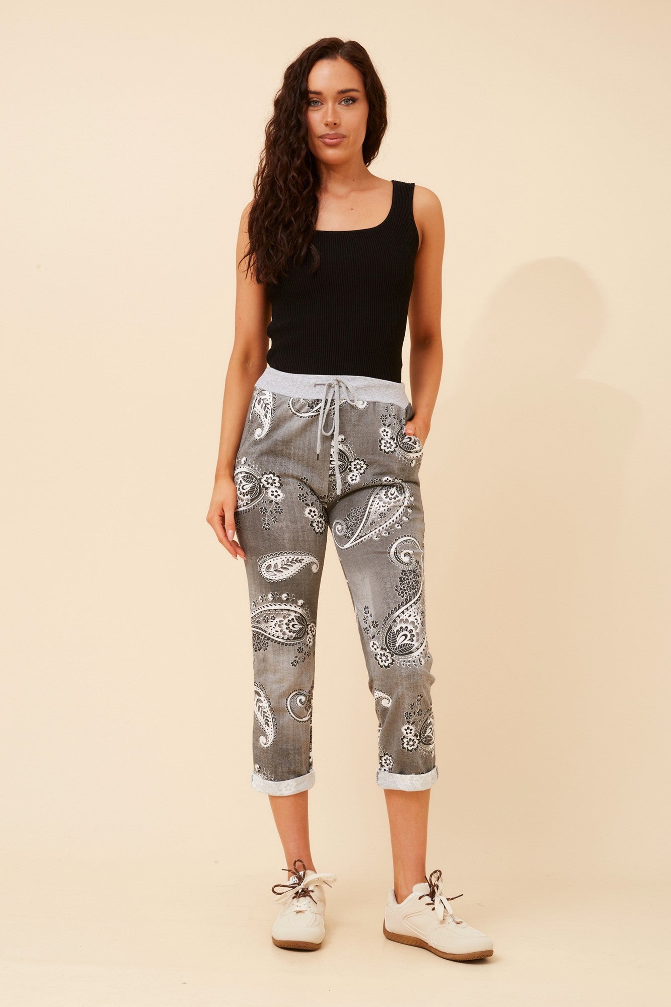 Image of a model wearing Pants. Product name - GINNA PAISLEY PRINT JOGGER PANTS in Black colour by brand - BOTTEGA MODA