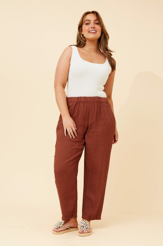 Image of a model wearing Pants. Product name - JOURNEE SOLID LINEN PANTS in Tobacco colour by brand - BOTTEGA MODA