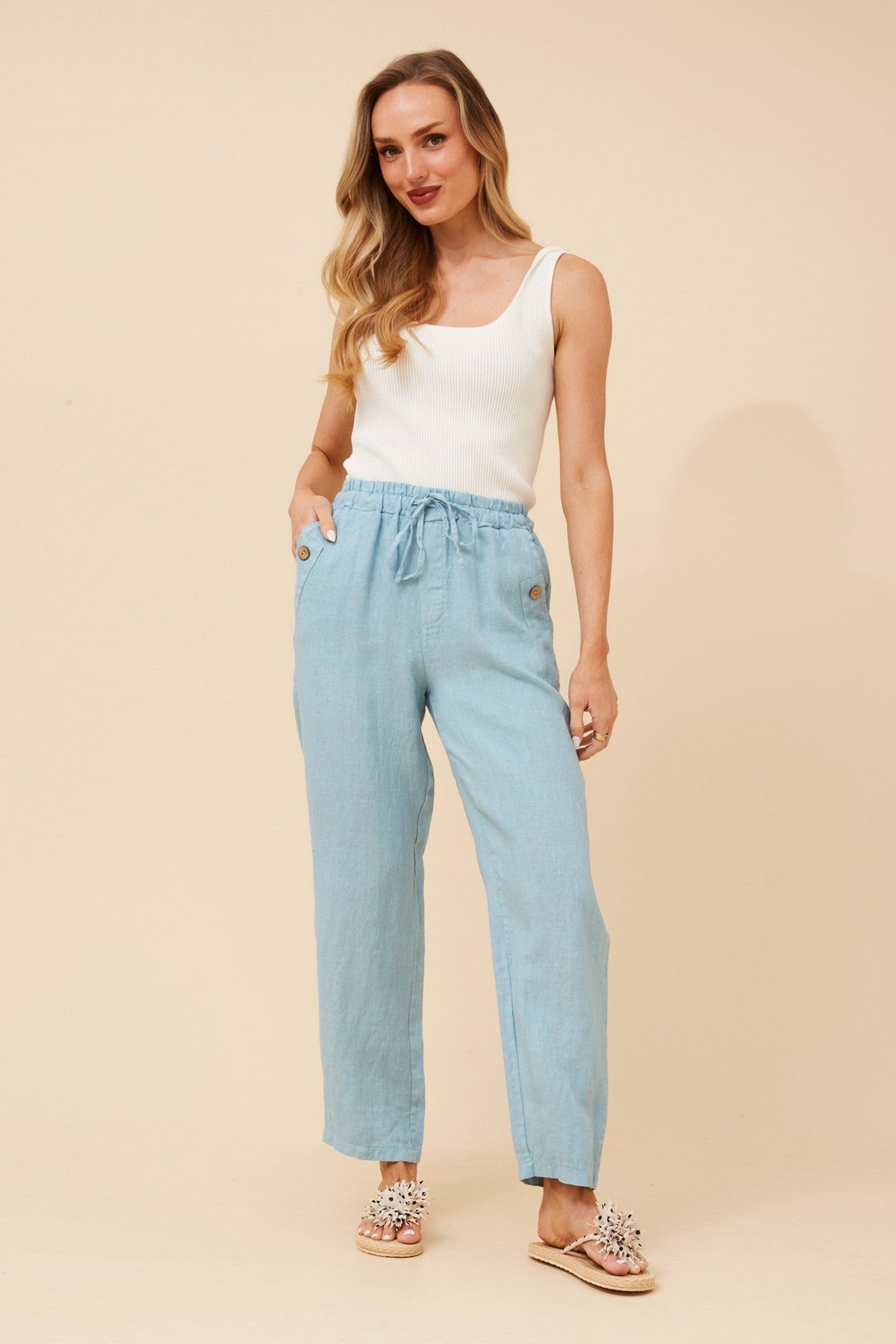 Image of a model wearing Pants. Product name - AMIR SOLID LINEN PANTS in Black colour by brand - BOTTEGA MODA