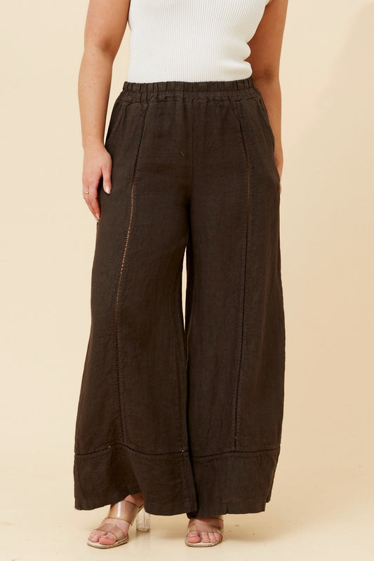 Image of a model wearing Pants. Product name - TEODORA LINEN WIDE LEG PANTS in Bitter Chocolate colour by brand - BOTTEGA MODA