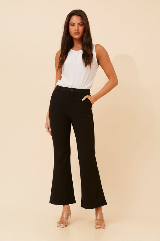 Image of a model wearing Pants. Product name - ELVISA FLARED LEG PANTS in Black colour by brand - Caroline Morgan Australia