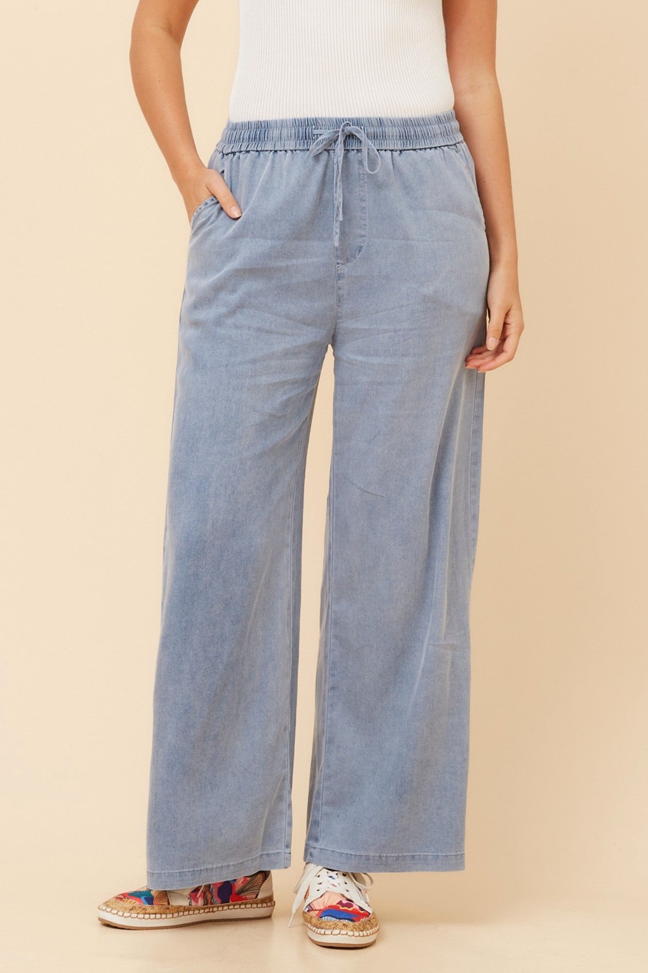 Image of a model wearing Pants. Product name - HANNE WIDE LEG PANTS in Blue colour by brand - Caroline Morgan Australia