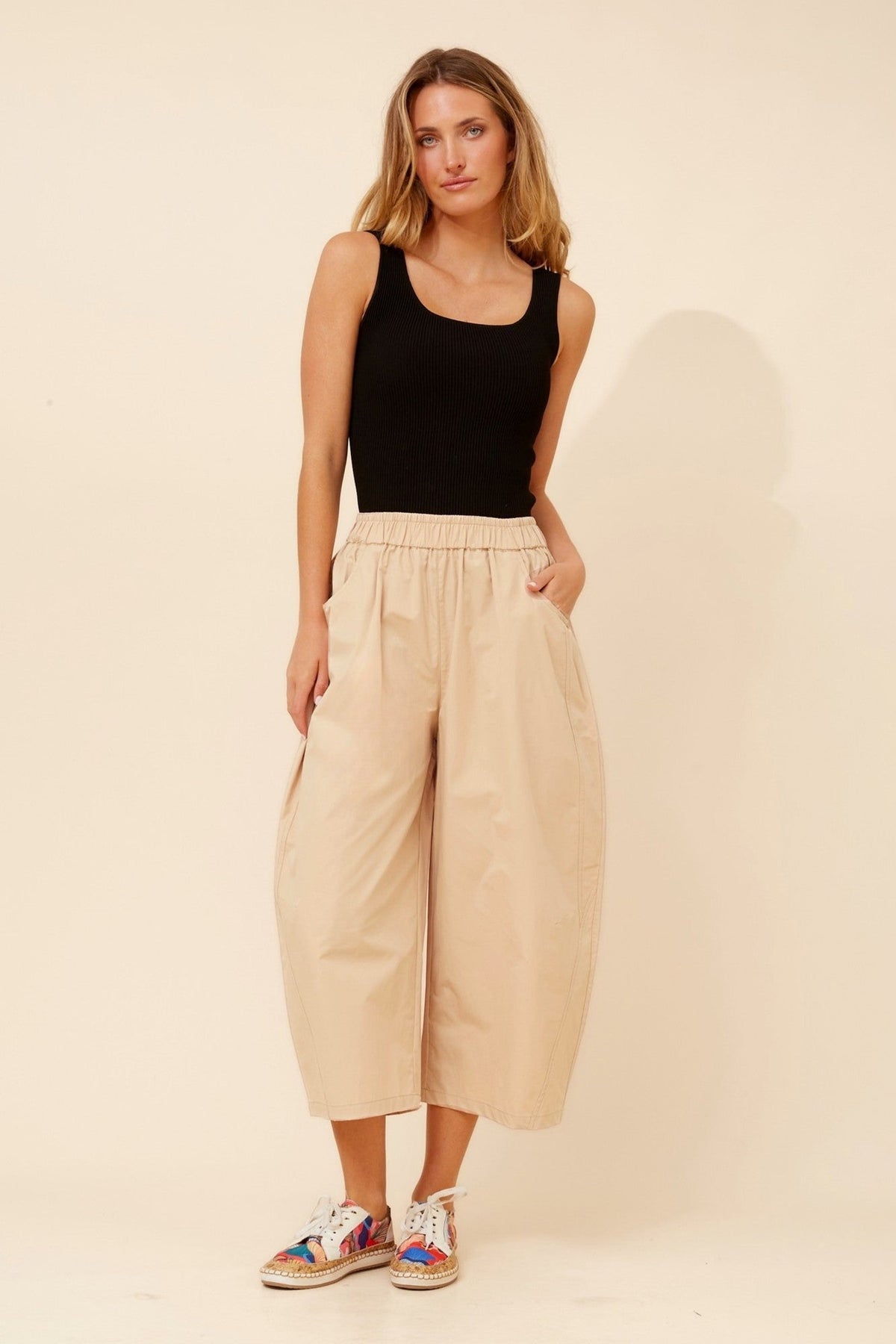Image of a model wearing Pants. Product name - OLIVET SOLID BARREL PANTS in Chocolate colour by brand - Caroline Morgan Australia