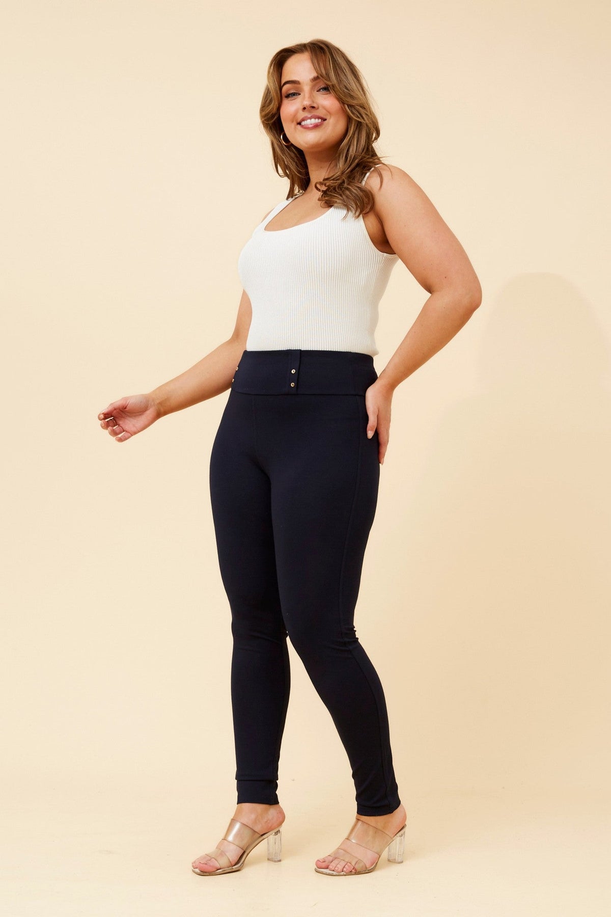 Image of a model wearing Pants. Product name - URSY SOLID LONG PANTS in Navy colour by brand - Caroline Morgan Australia