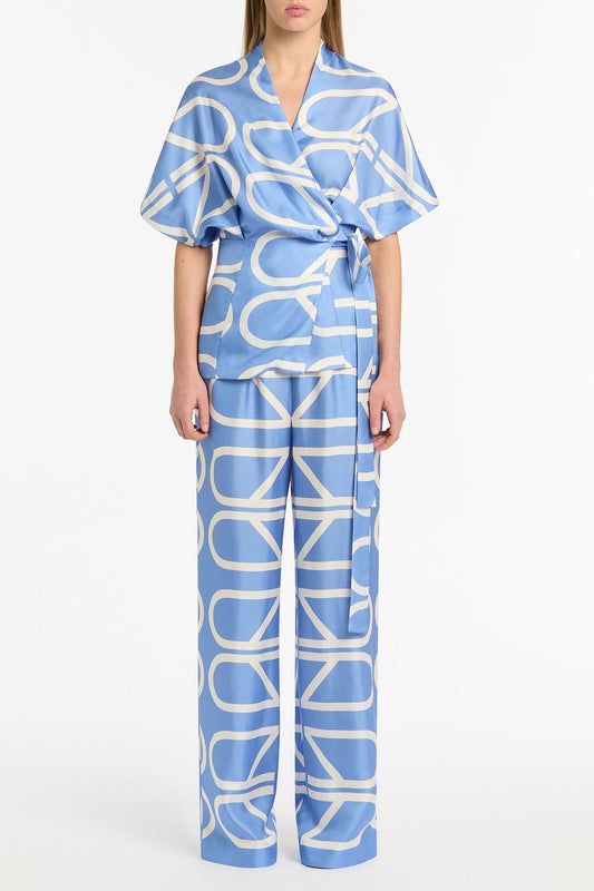 Image of a model wearing Pants. Product name - Pacific Blue And Ivory Grid Silk Twill Elastic Pant in Blue colour by brand - Carla Zampatti