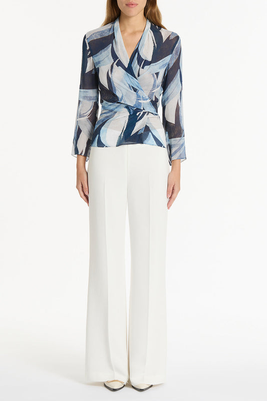 Image of a model wearing Tops. Product name - Painted Floral Georgette Wrap Top in Blue colour by brand - Carla Zampatti