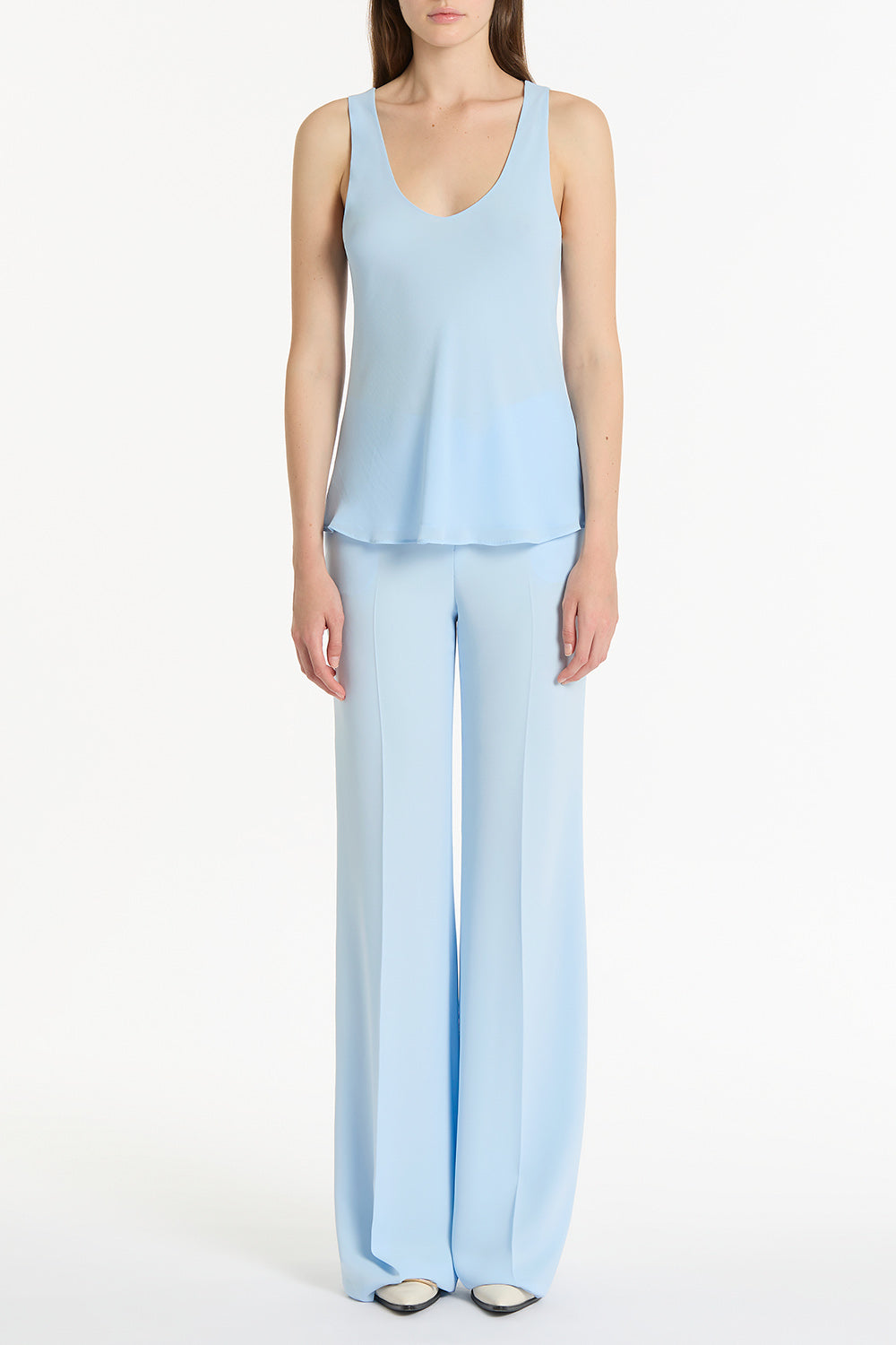 Image of a model wearing Pants. Product name - Pale Blue Crepe Low Waist Pant in Blue colour by brand - Carla Zampatti