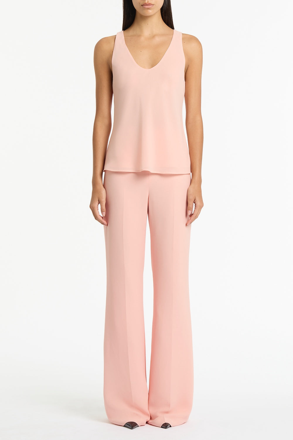 Image of a model wearing Tops. Product name - Pale Rose Georgette Scoop Cami in Pink colour by brand - Carla Zampatti