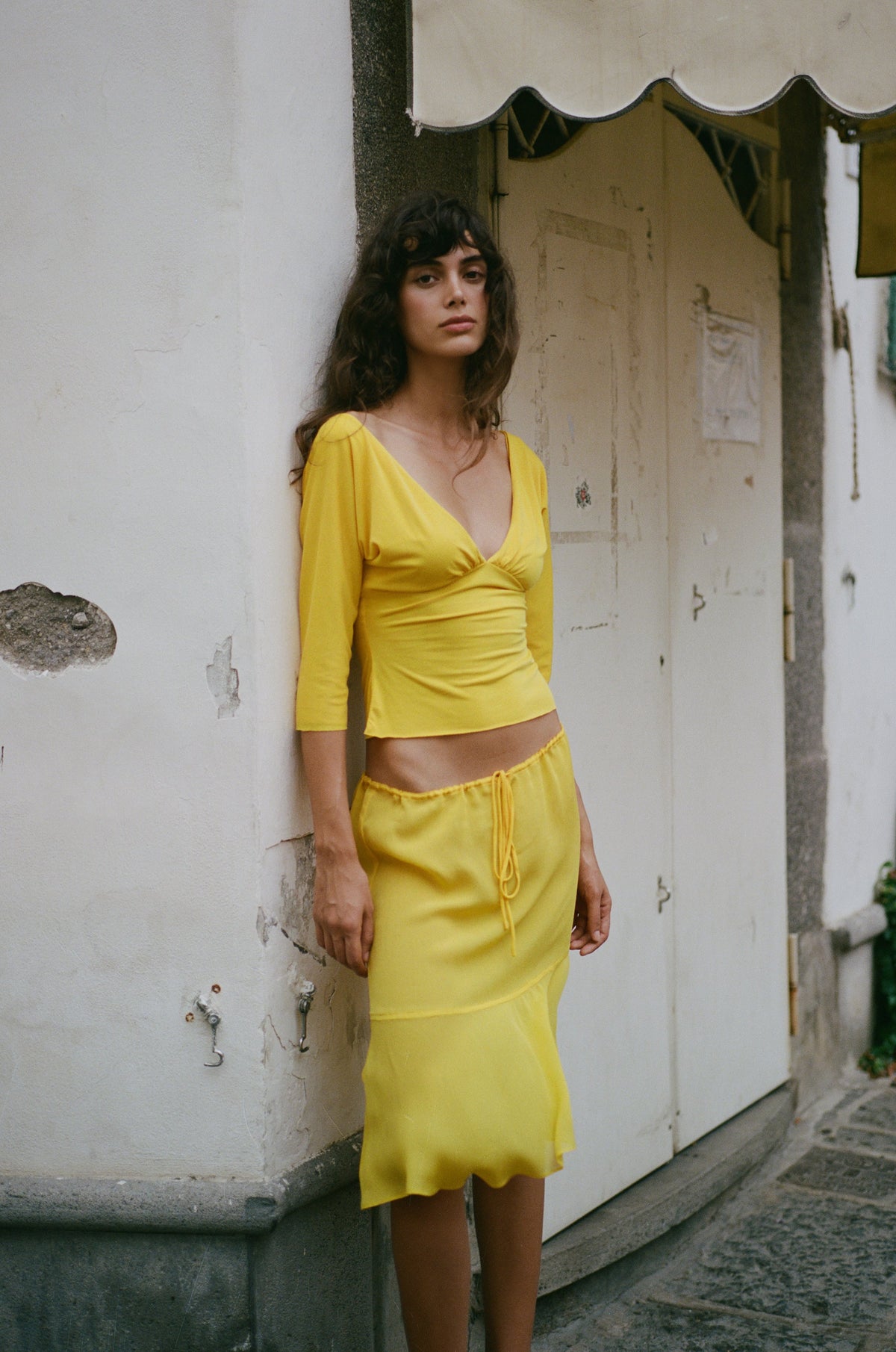 Image of a model wearing Skirts. Product name - Pali Skirt in Golden Yellow colour by brand - With Jéan