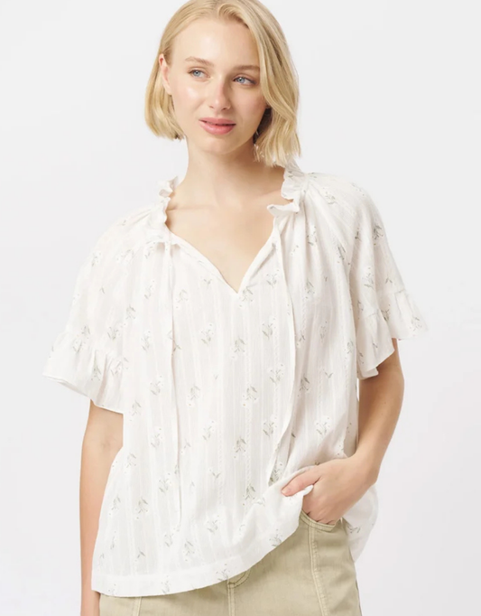 Image of a model wearing Tops. Product name - Patricia Shirt White With Flowers in White colour by brand - Kireina