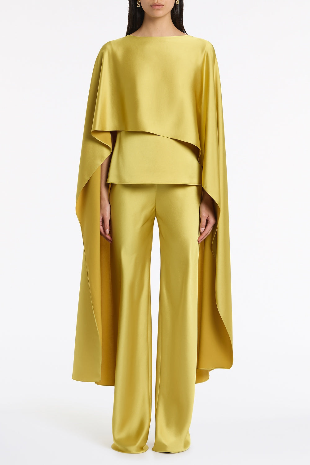 Image of a model wearing Tops. Product name - Pear Lustre Satin Long Cape Top in Green colour by brand - Carla Zampatti