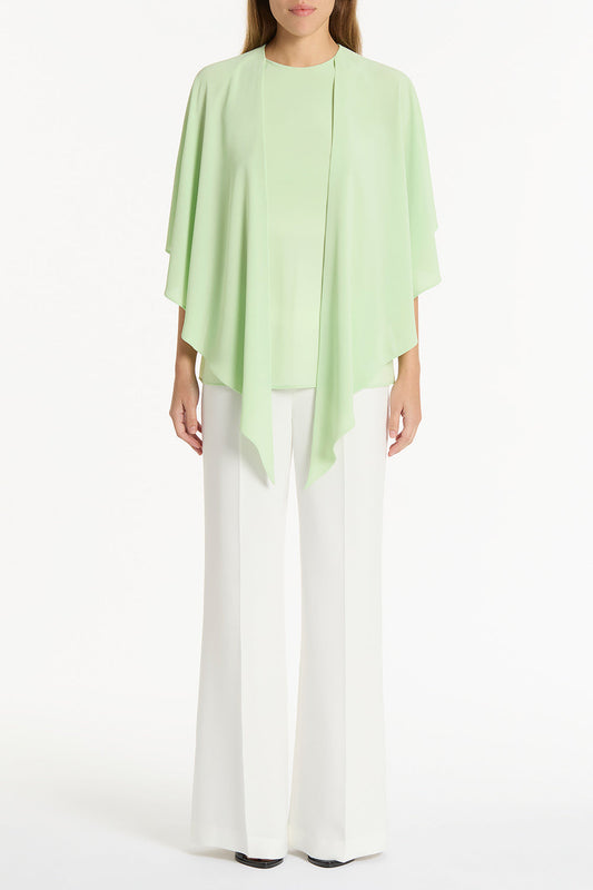 Image of a model wearing Tops. Product name - Peridot Georgette Cascata Top in Green colour by brand - Carla Zampatti