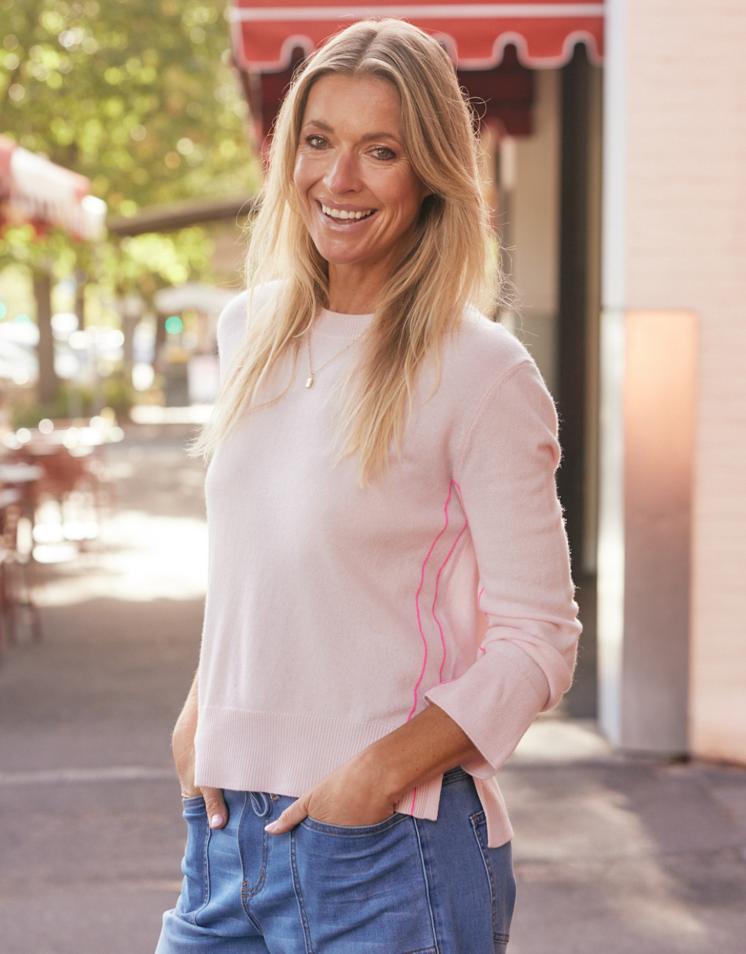 Image of a model wearing Outerwear. Product name - Riviera Wool Cashmere Knit Ice Pink in Ice Pink colour by brand - White & Co.