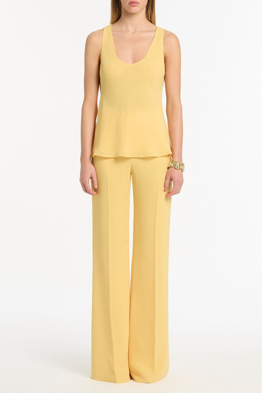 Image of a model wearing Tops. Product name - Pollen Georgette Scoop Neck Cami in Yellow colour by brand - Carla Zampatti