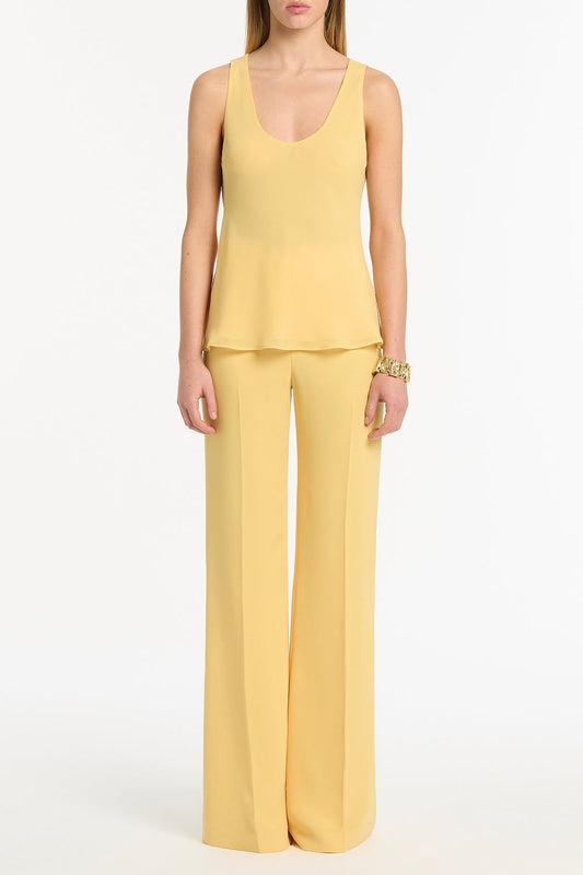 Image of a model wearing Tops. Product name - Pollen Georgette Scoop Neck Cami in Yellow colour by brand - Carla Zampatti