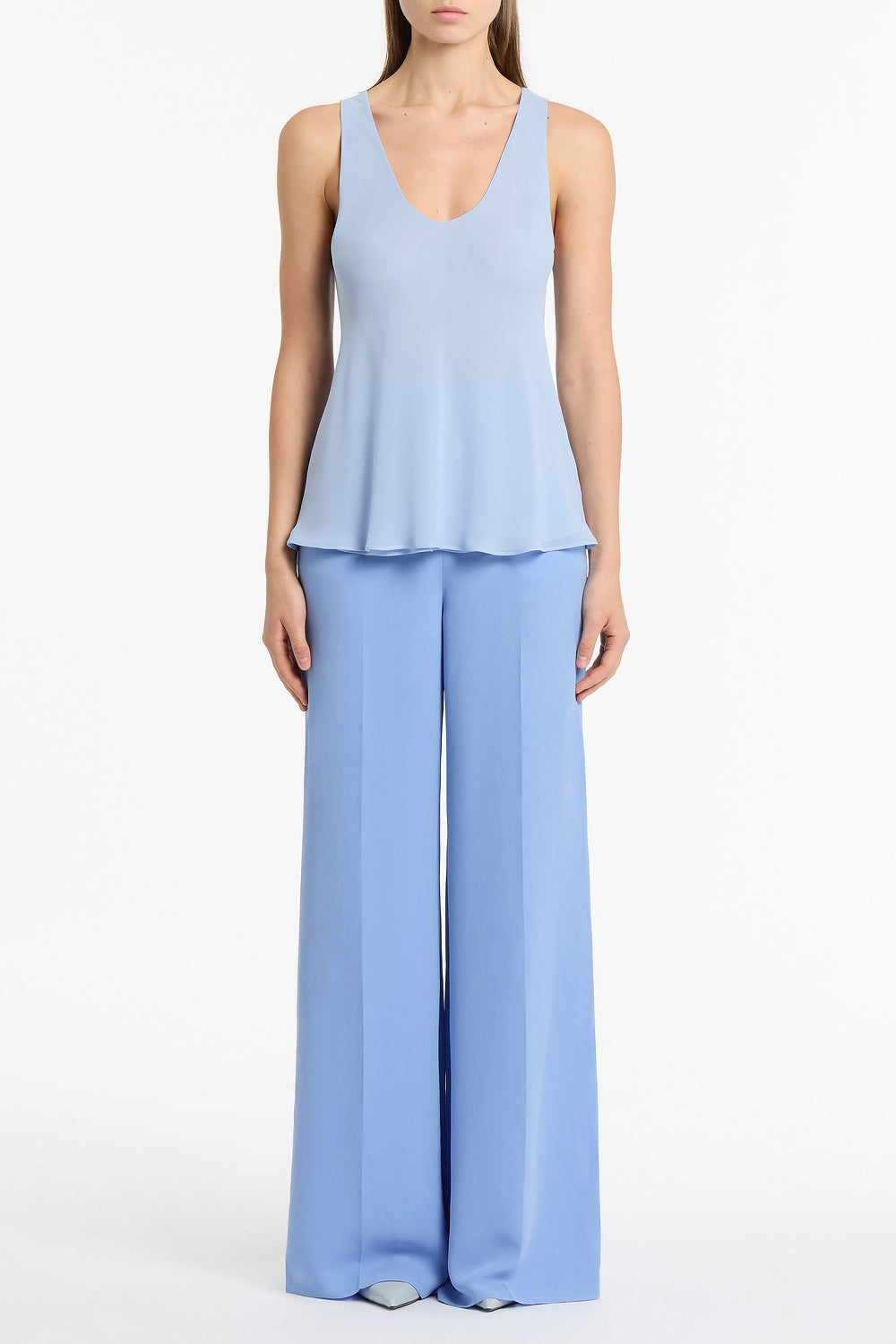 Image of a model wearing Tops. Product name - Powder Blue Georgette Scoop Cami in Blue colour by brand - Carla Zampatti