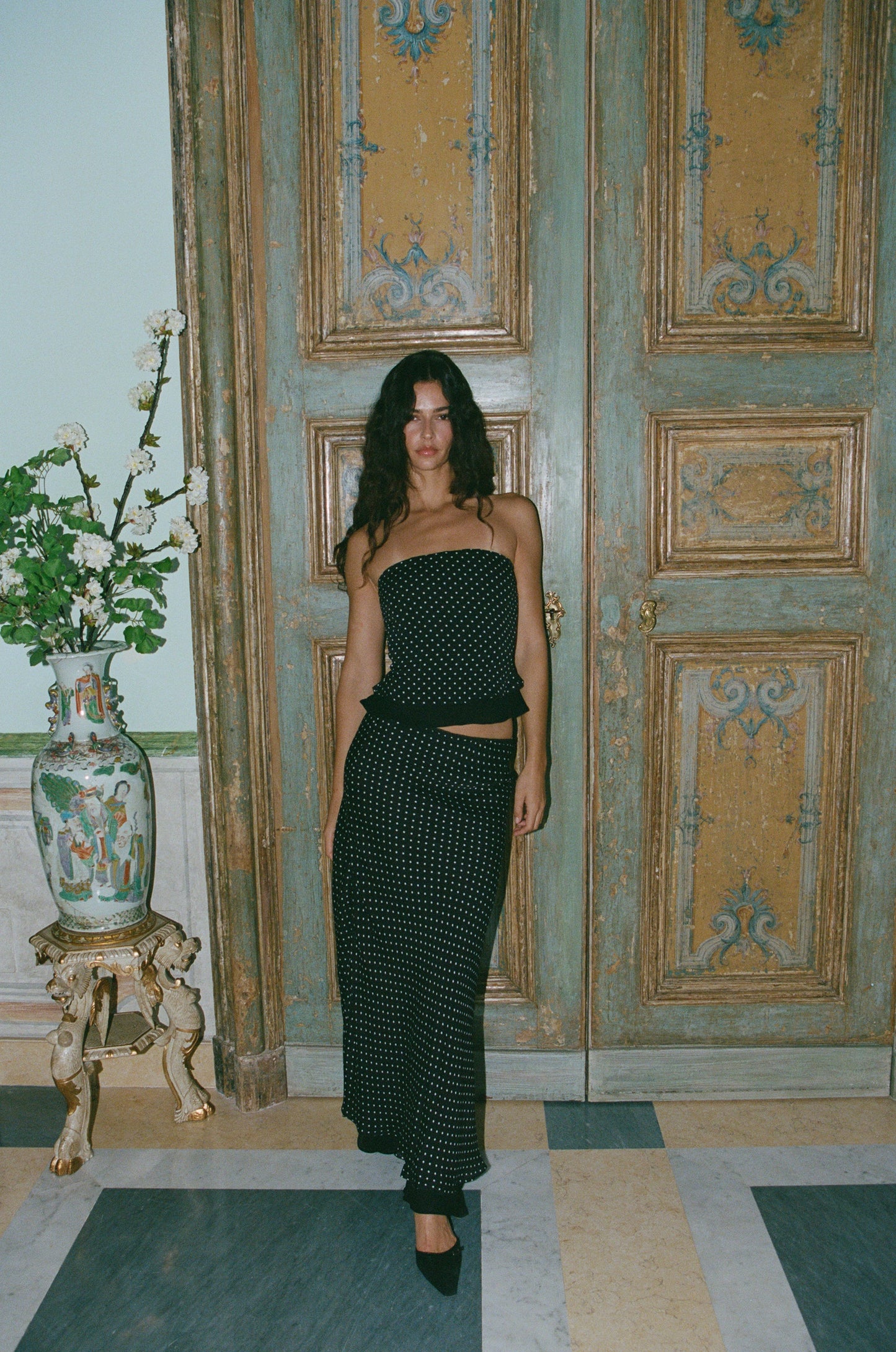 Image of a model wearing Skirts. Product name - Priya Midi Skirt in Polka Dot colour by brand - With Jéan
