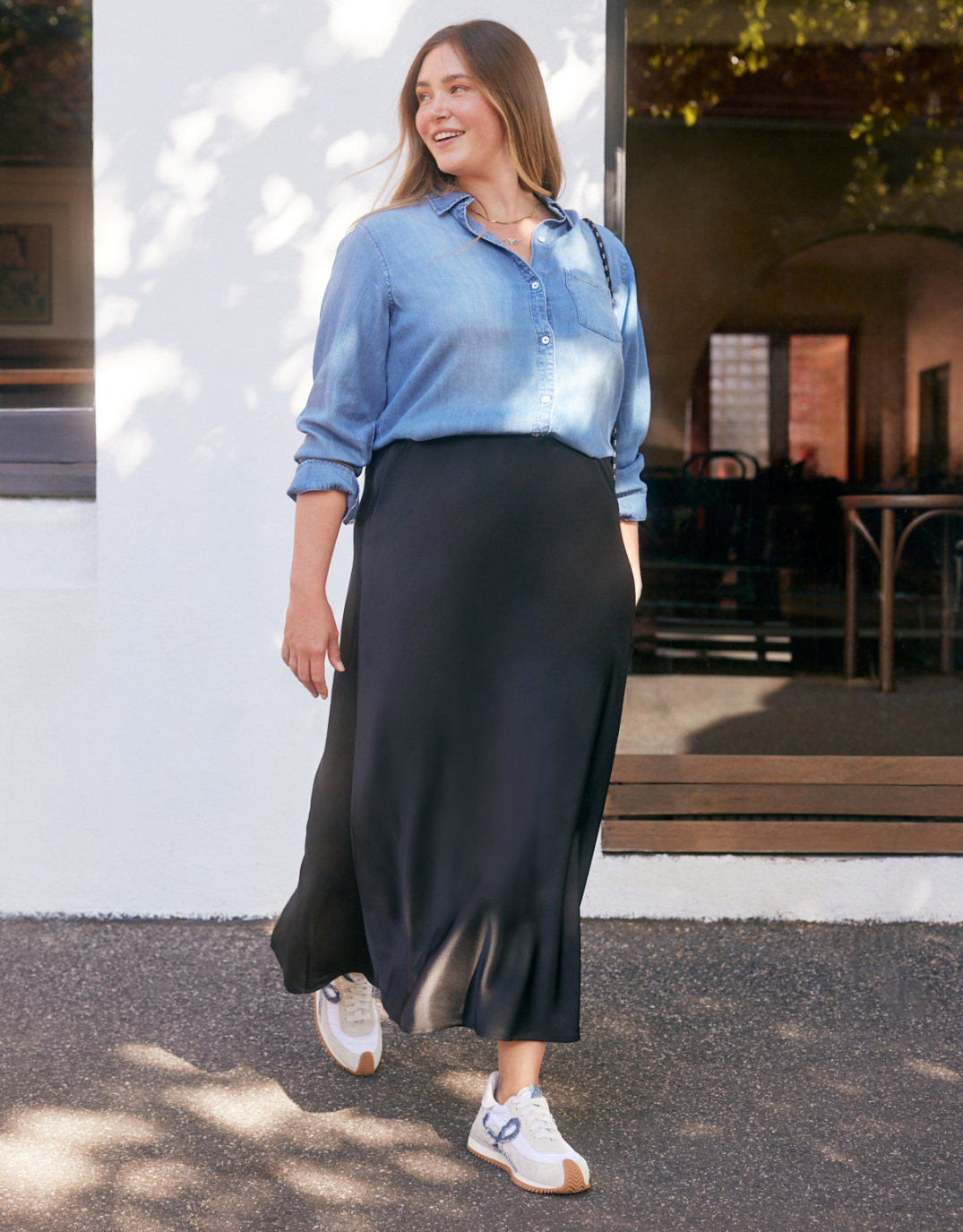 Image of a model wearing Skirts. Product name - Prodigy Satin Bias Maxi Skirt Black in Black colour by brand - Stories Be Told