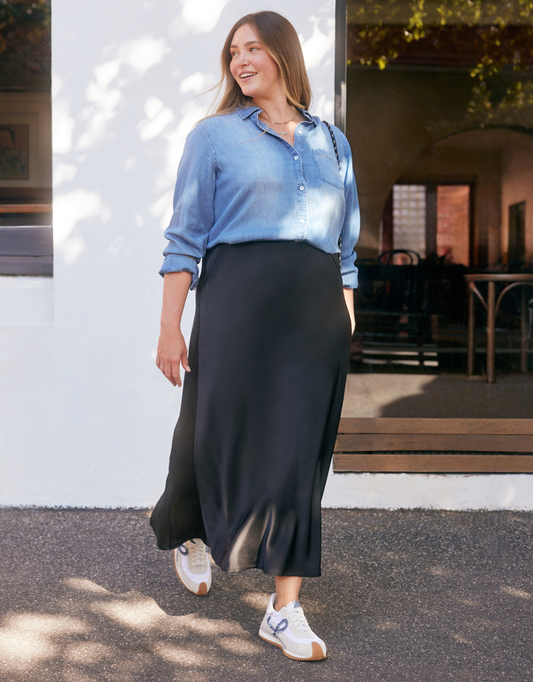 Image of a model wearing Skirts. Product name - Prodigy Satin Bias Maxi Skirt Black in Black colour by brand - Stories Be Told